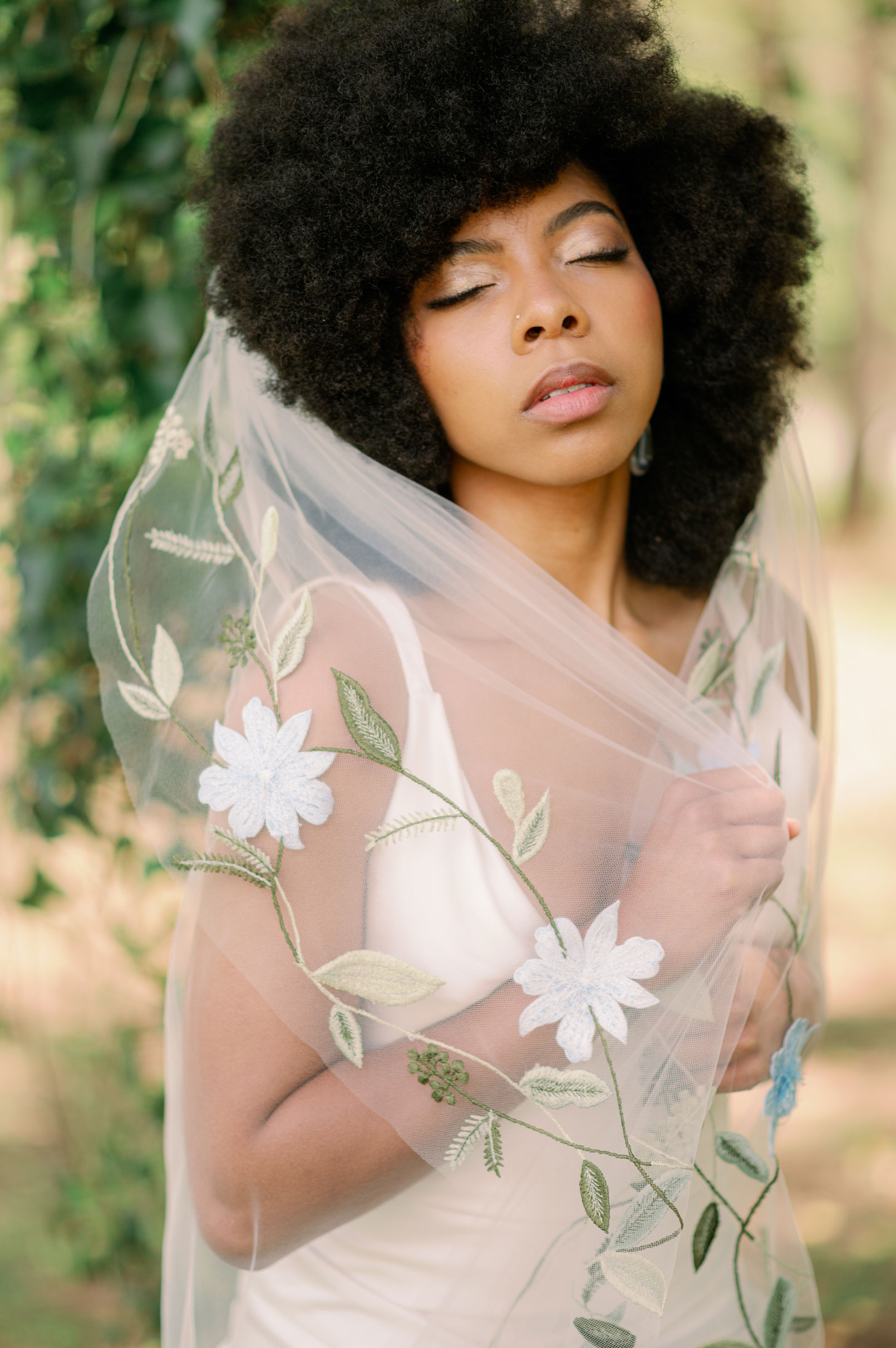 The bride holds her veil for her wedding day.