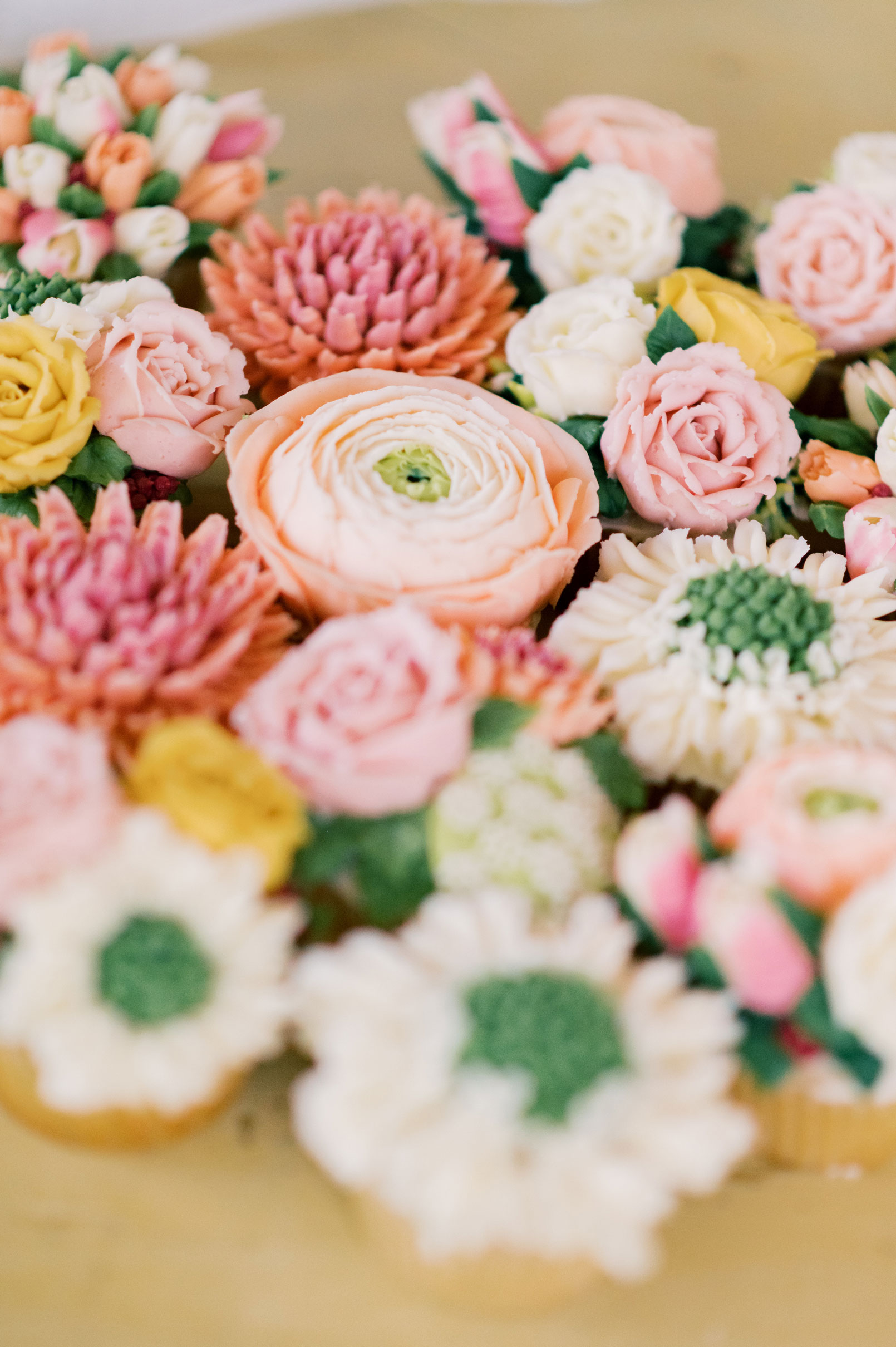 Cupcakes are decorated to look like flowers.