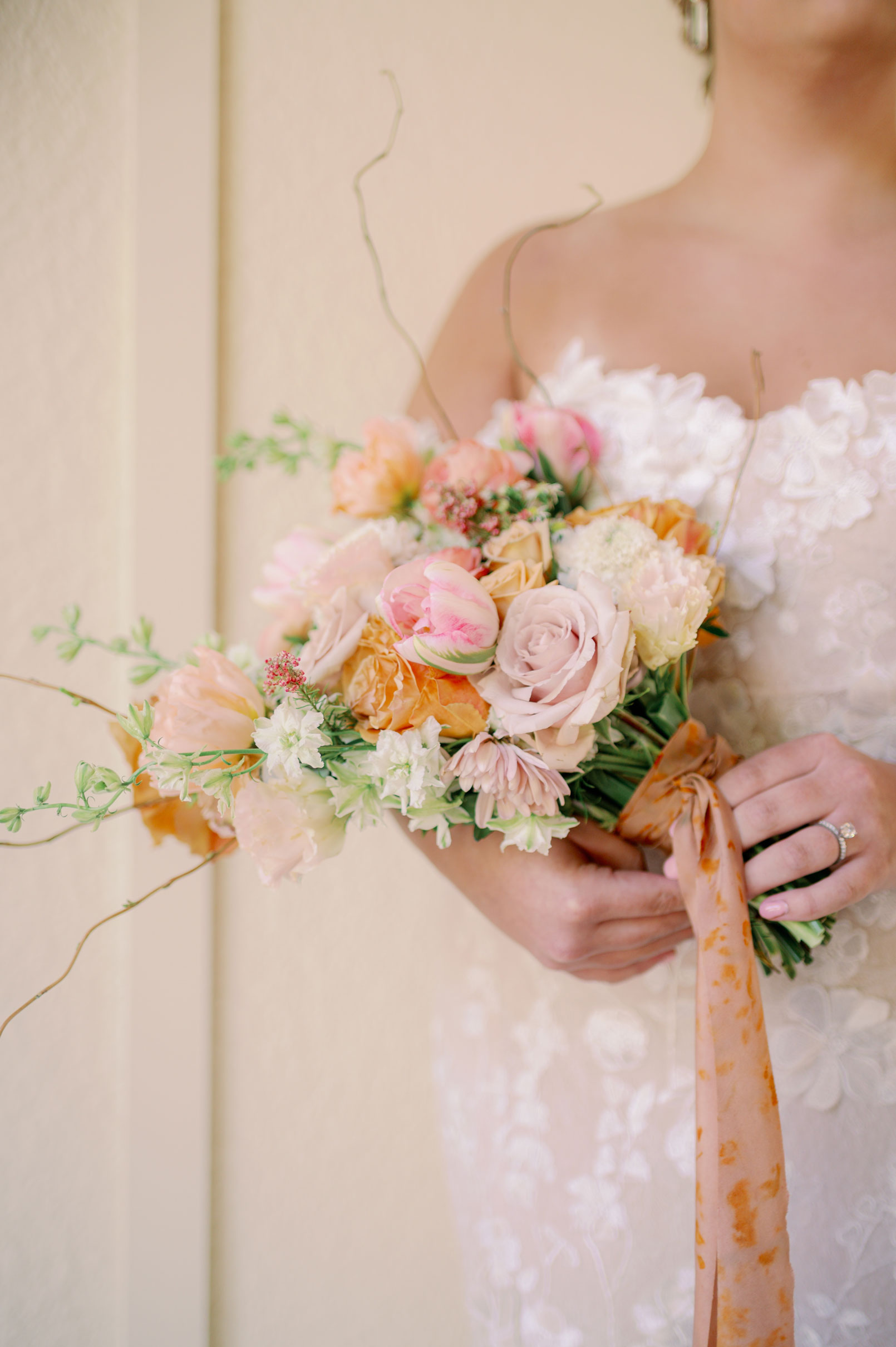 The bride holds a spring bouquet for a wedding in Alabama.