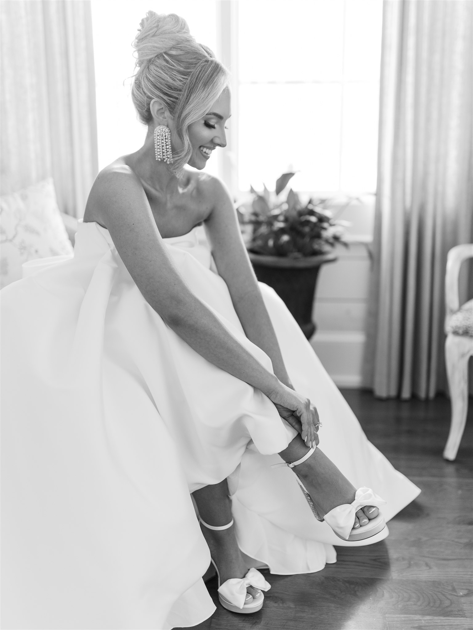 The bride puts on her shoes before her Alabama wedding day.