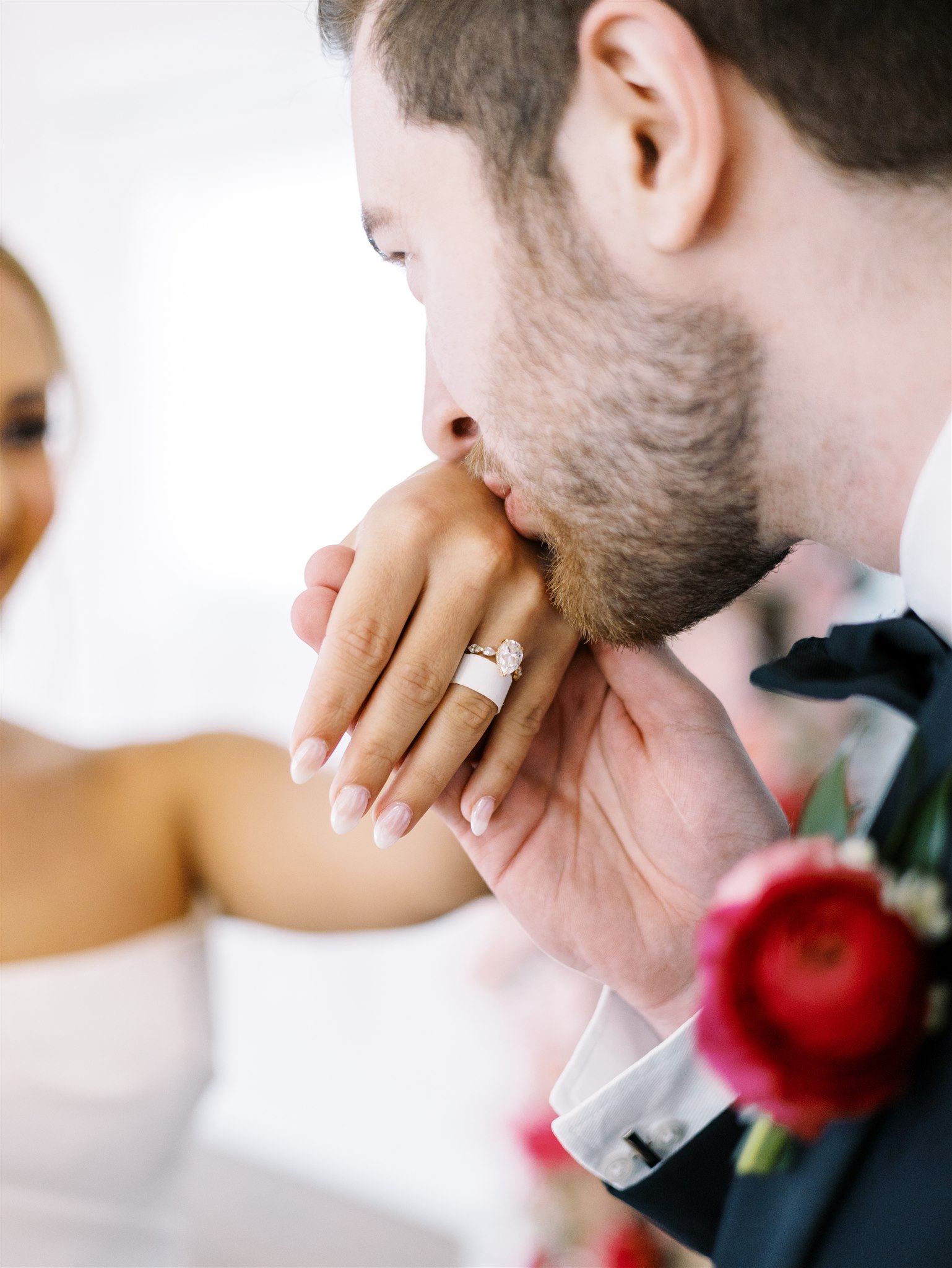 The bride shows her sentimental paper ring her groom gave her in college.