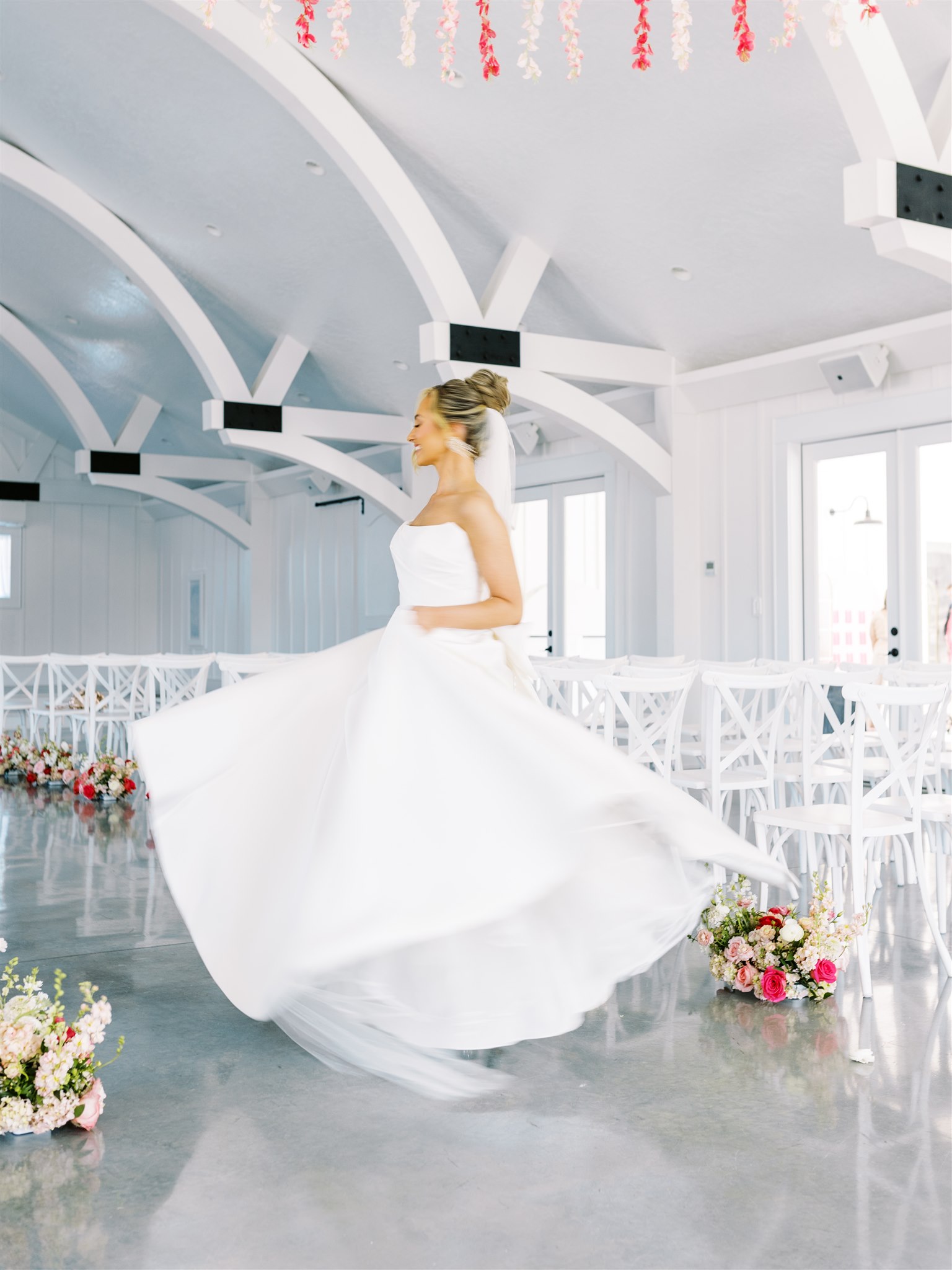 The bride spins in her wedding dress at Oak Meadow Event Center.