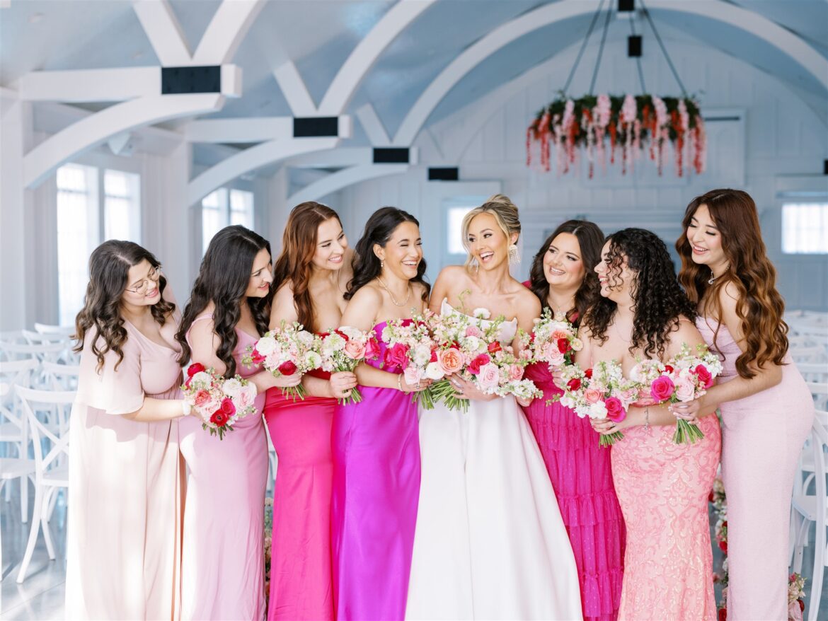 Bridesmaids wearing different pink dresses for a wedding at Oak Meadow Event Center in Alabama.