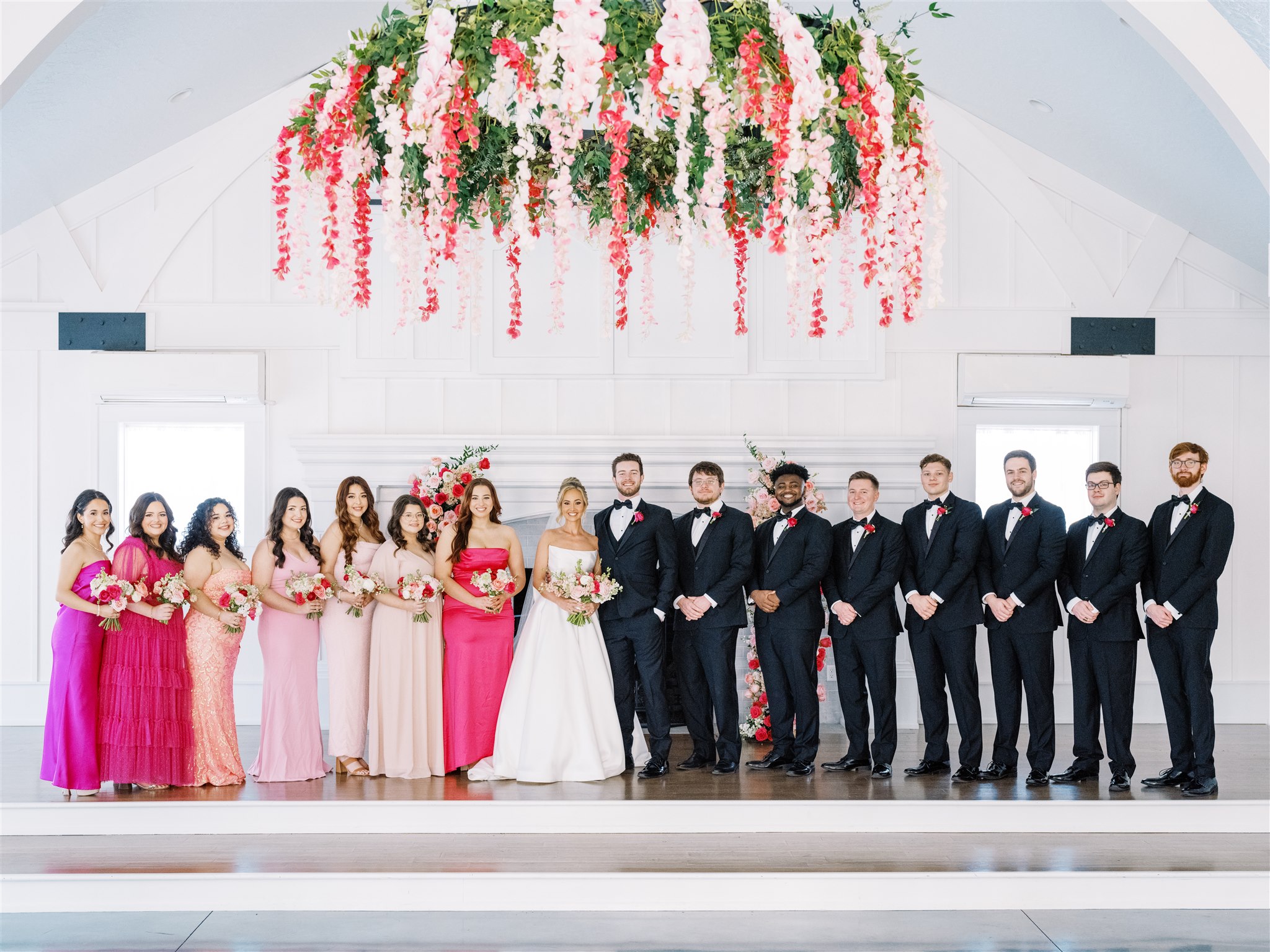 The wedding party poses together in from of the ceremony site in Alabama