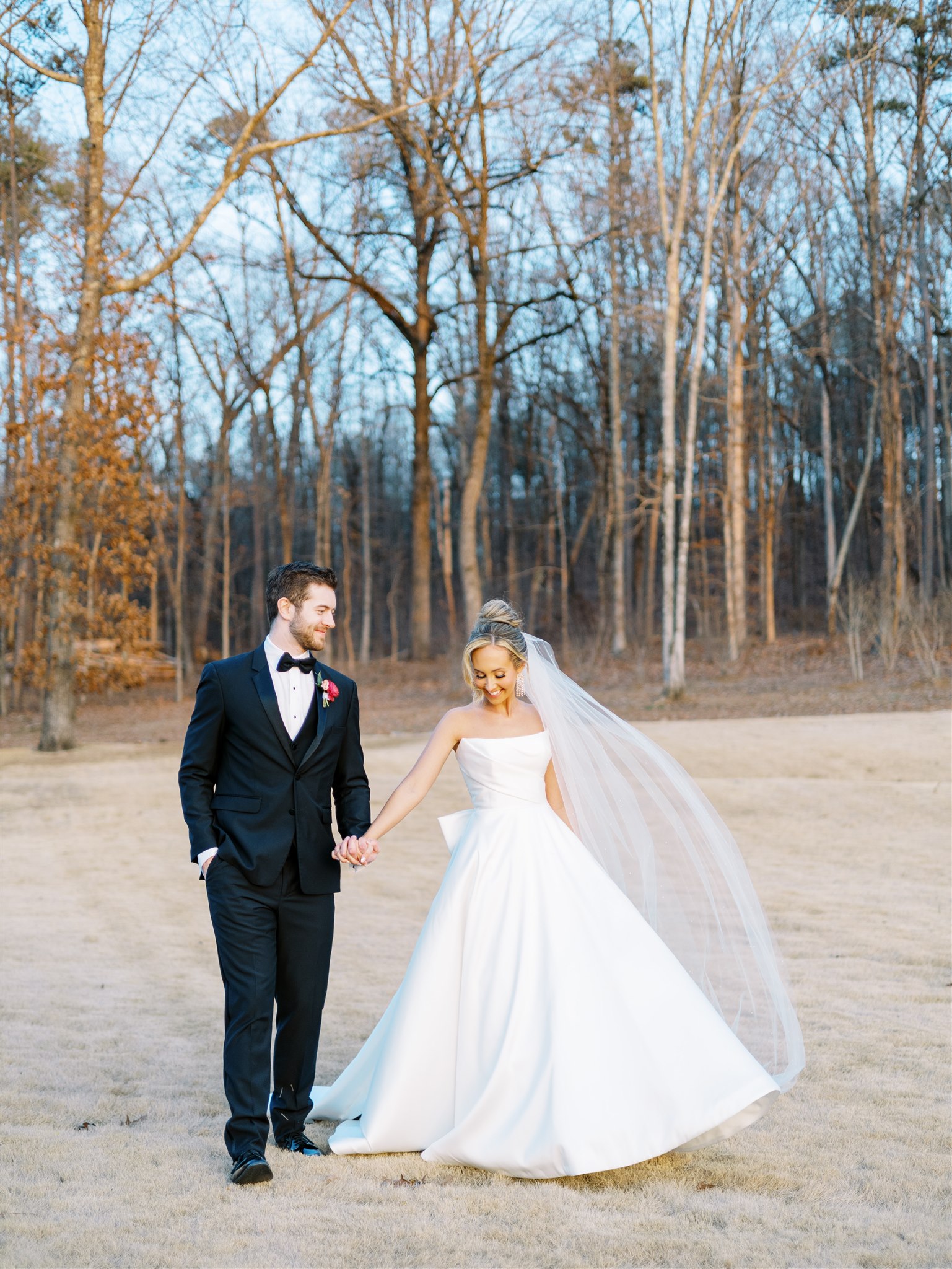 The bride and groom walk together at the wedding.