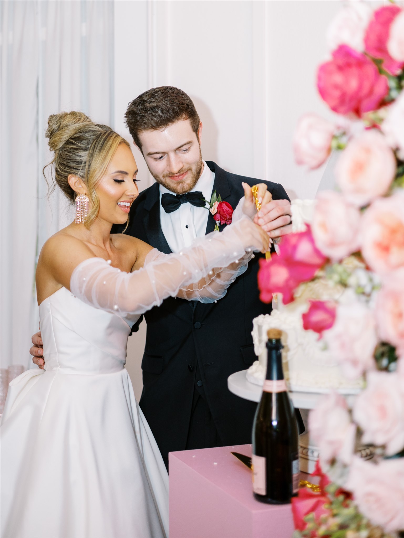 The bride and groom cut the cake at their Alabama wedding.