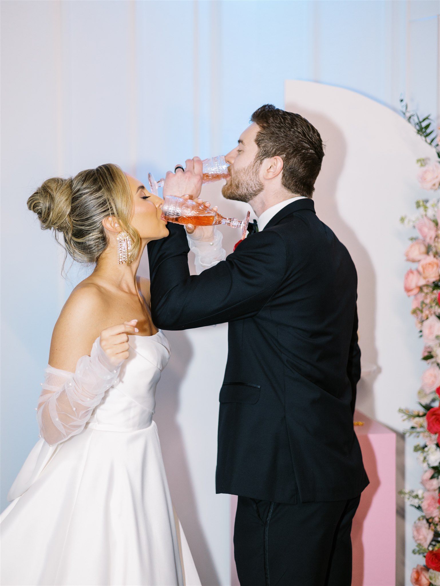 The bride and groom share a sip of champagne at their wedding in Alabama.