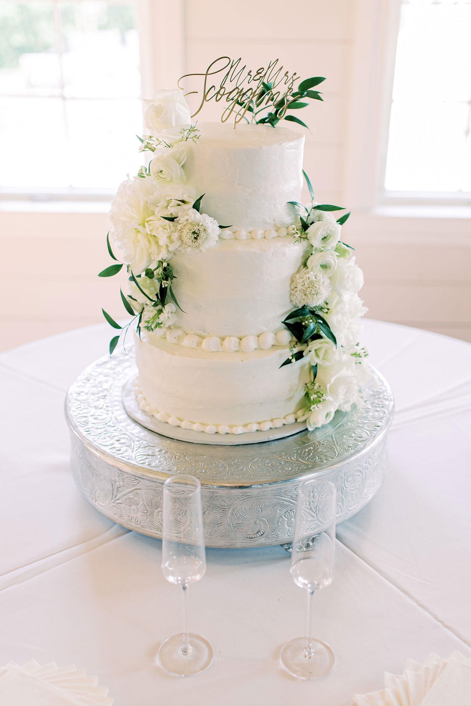 The classic white cake is decorated with fresh flowers for the wedding in Florence, Alabama.