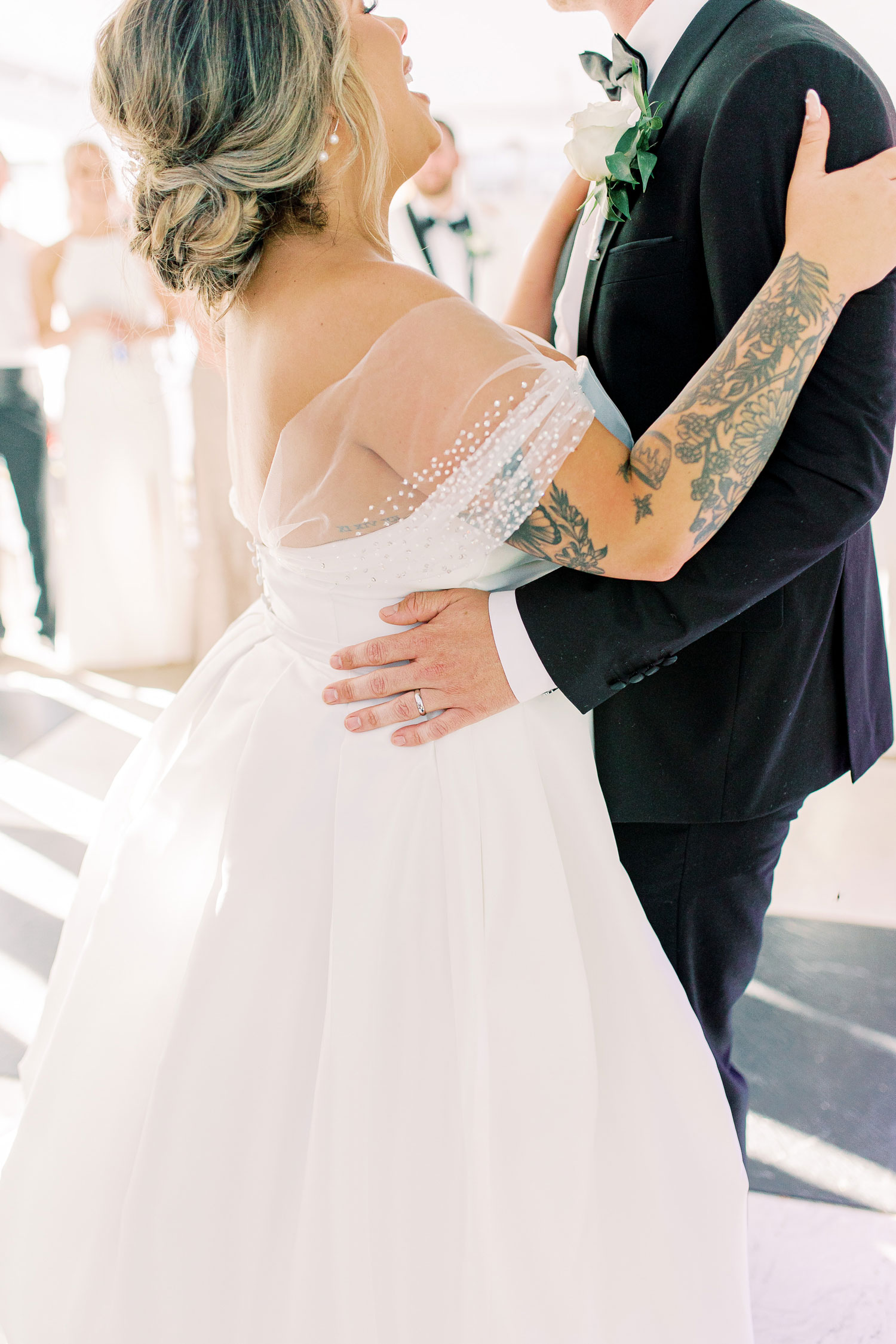 The groom embraces the bride on the dance floor in Alabama.