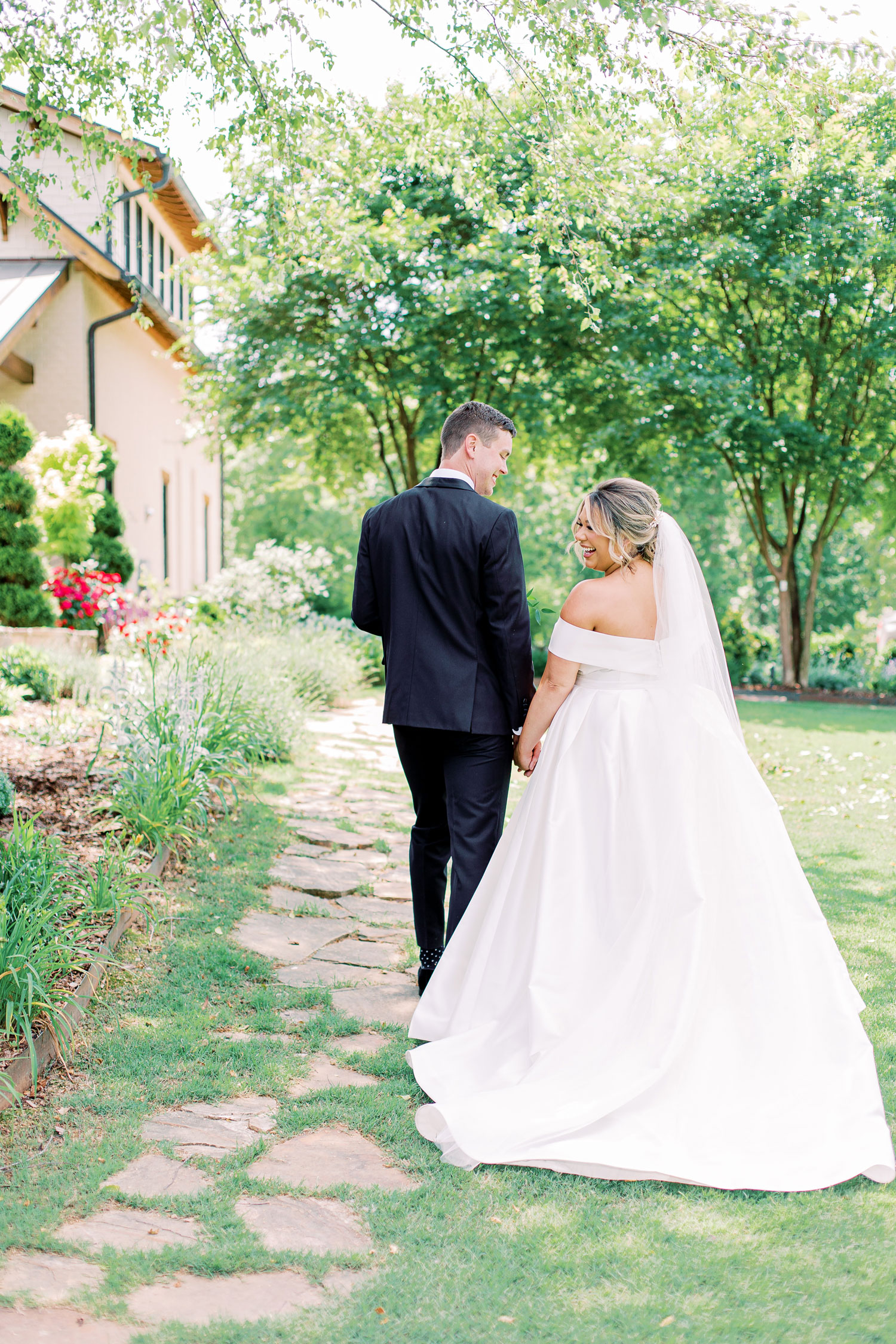 The bride and groom hold hands as they prepare for their Alabama wedding reception.